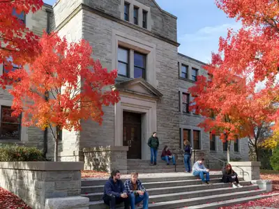 An Ontario university's stone library building on a crisp autumn day.